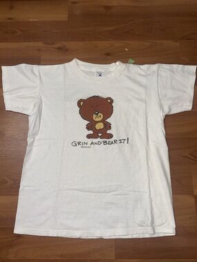 Vintage 90s Delta white graphic t-shirt grin and bear it cartoon bear